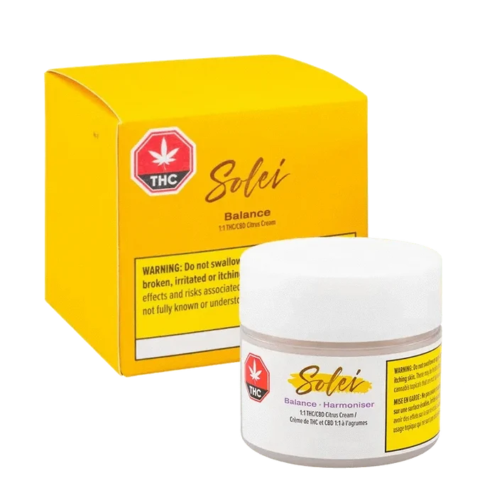 A close-up of the Balance Body Cream packaging, featuring a vibrant yellow label with prominent text and a cannabis leaf icon.