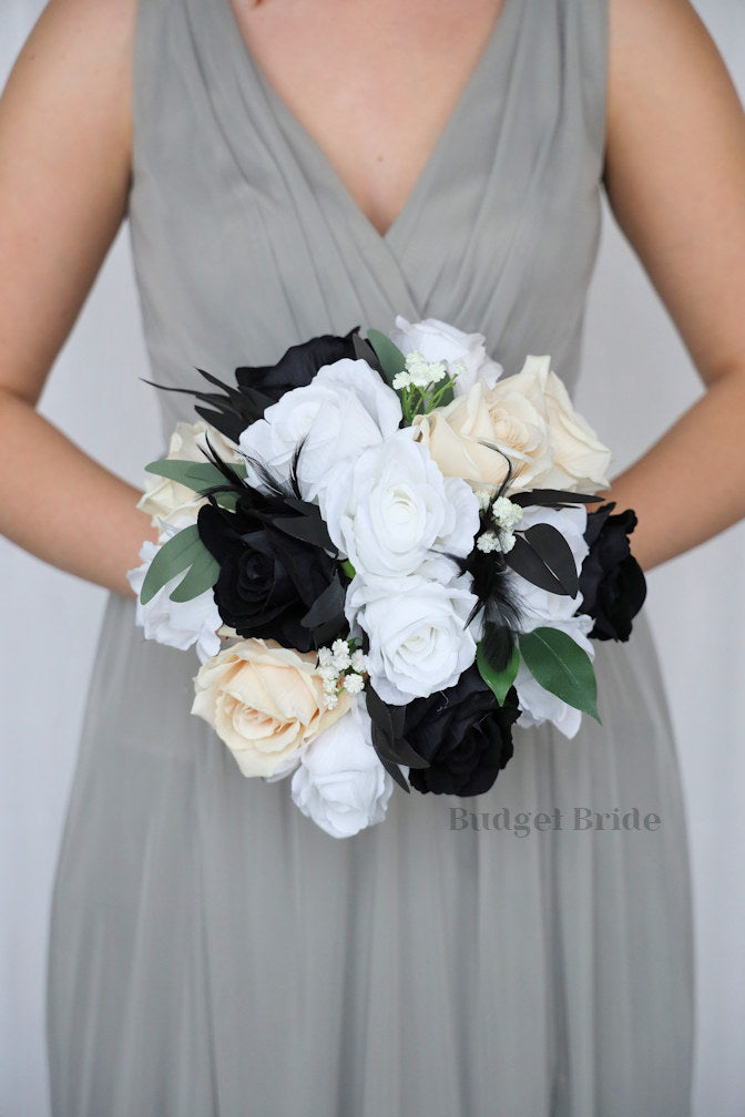Brides bouquet with black, white and champagne ivory roses with black feathers
