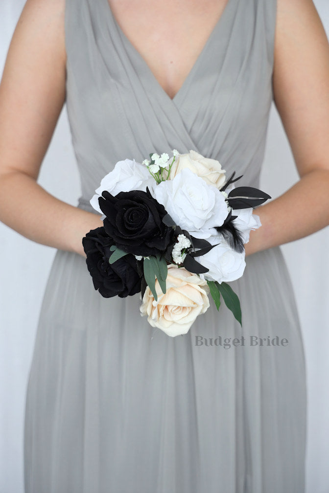 Brides bouquet with black, white and champagne ivory roses with black feathers
