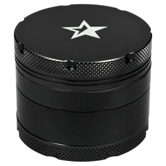 Close-up top-down view of the Famous X 4 pc Grinder -Black - 50mm showing its matte black lid with a silver star logo and textured knurled edges.