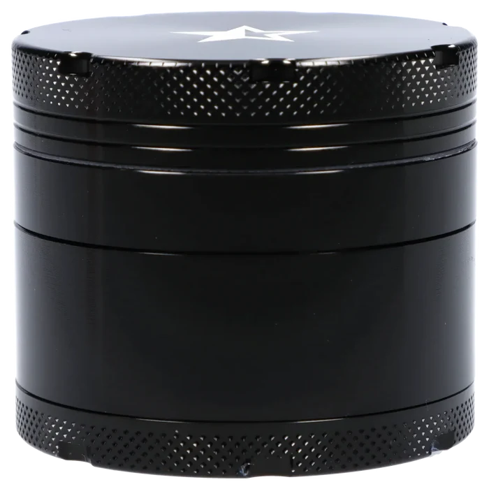 Close-up front view of the Famous X 4 pc Grinder -Black - 50mm showing its textured knurled top, stacked cylindrical sections, and a white star on the lid.