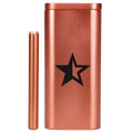 Close-up front view of the Famous X Aluminum Dugout - Rose Gold showing its metallic rose-gold finish, black star logo, and matching bat against a white background.