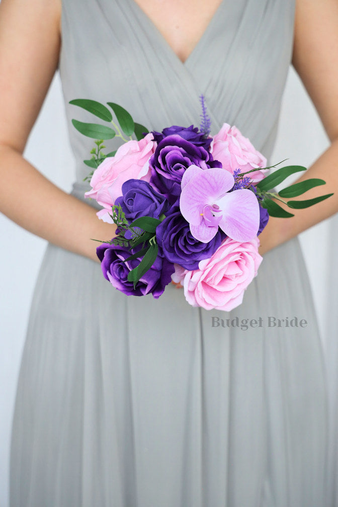 Purple rose and purple orchid brides bouquet with pink roses and green leaves