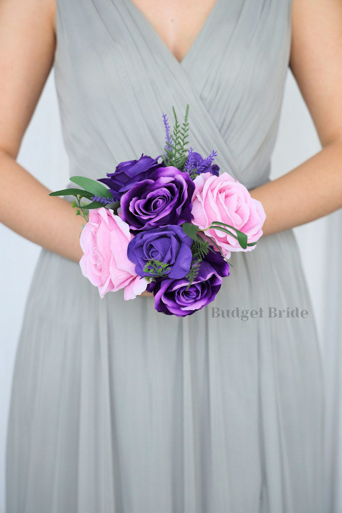 Purple rose and purple orchid brides bouquet with pink roses and green leaves
