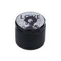 A close-up, top-down view of the black Rock Legends Jimmy-Love Grinder, showcasing its circular design with detailed engravings.