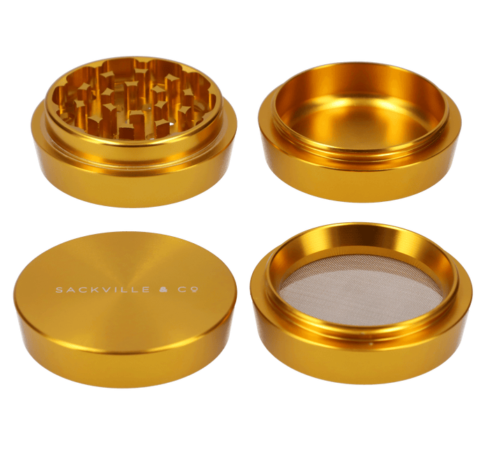 A top-down view of the gold Sackville and Co 4pc Grinder, showcasing its four-piece construction and metallic sheen.